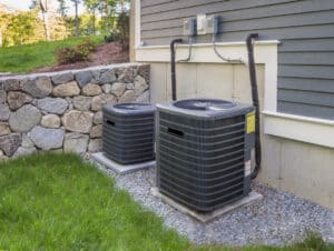 Residential heating and air conditioner compressor units near suburban house